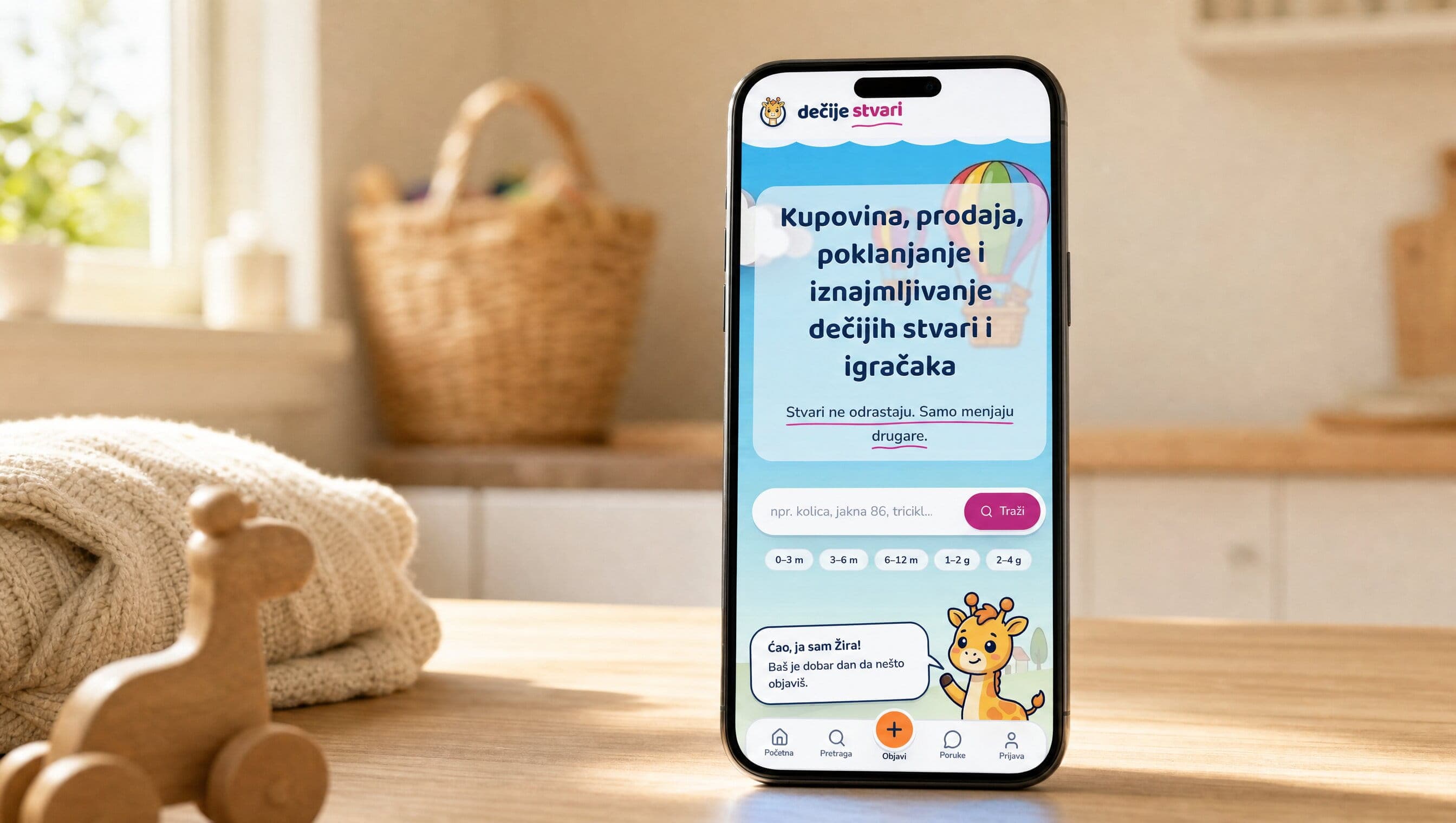 Dečije Stvari home screen on a phone standing on a kitchen counter in morning light